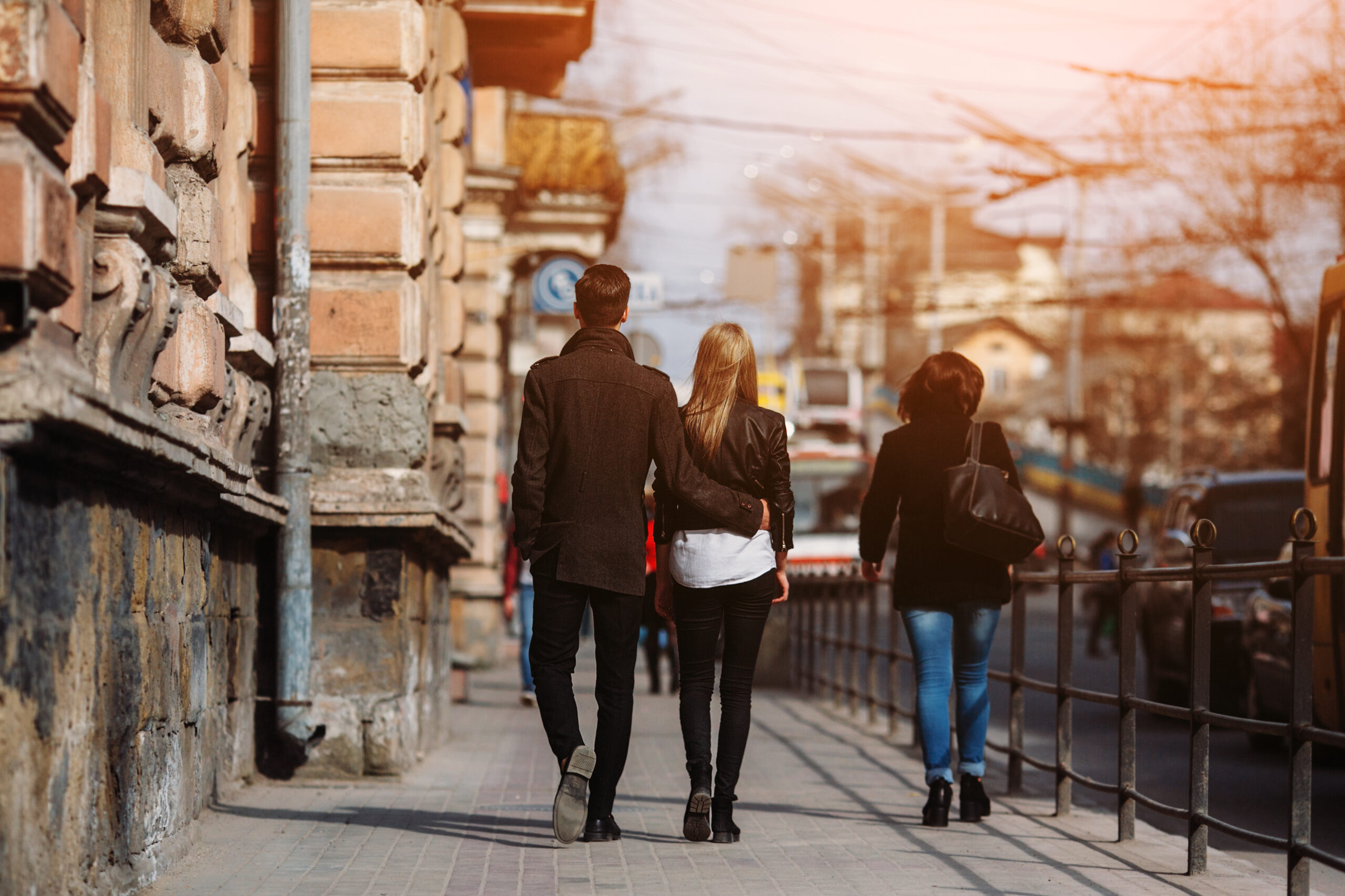 Photo of a young beautiful couple on busy city street